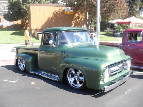 1990 Ford Bronco - Customized 1956 Ford F-100 pickup truck with chrome wheels and a lowered stance.