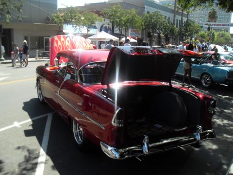 1990 Ford Bronco - Classic 1955 Chevrolet Bel Air coupe with custom flame paint on the hood and open trunk.