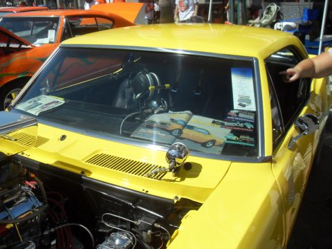 1990 Ford Bronco - A bright yellow coupe is displayed, with a magazine a similar car on its dashboard.