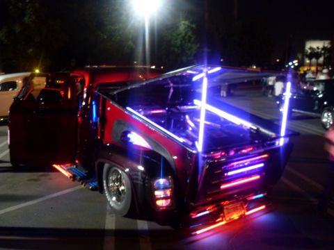 1990 Ford Bronco - This heavily modified pickup truck features extensive neon lighting, altering its appearance significantly.