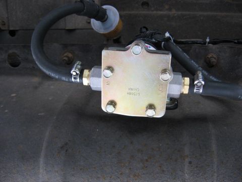 1979 Ford Bronco - Aftermarket fuel pump and filter assembly with hoses and clamps.