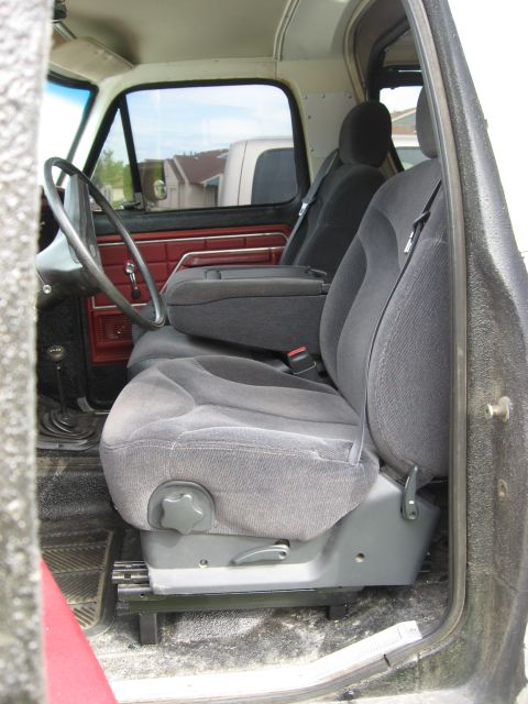 1979 Ford Bronco - The interior of a truck is visible, with a second vehicle seen through the side window.