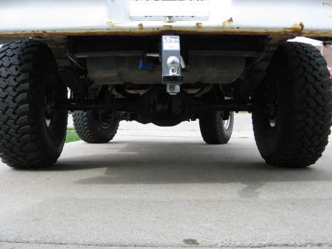 1979 Ford Bronco - Underside view of a truck's rear axle, fuel tank, and trailer hitch.