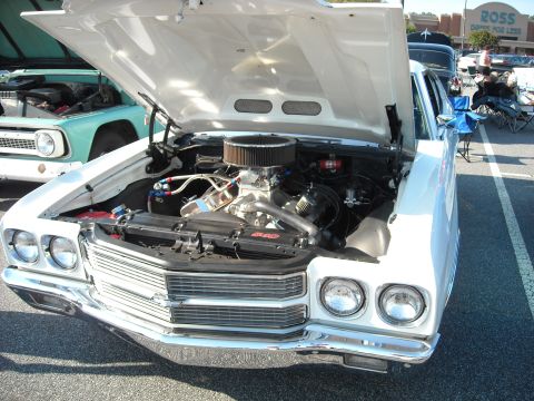1979 Ford F-150 - A white 1970 Chevrolet Chevelle is displayed with its hood open, showing the engine compartment.