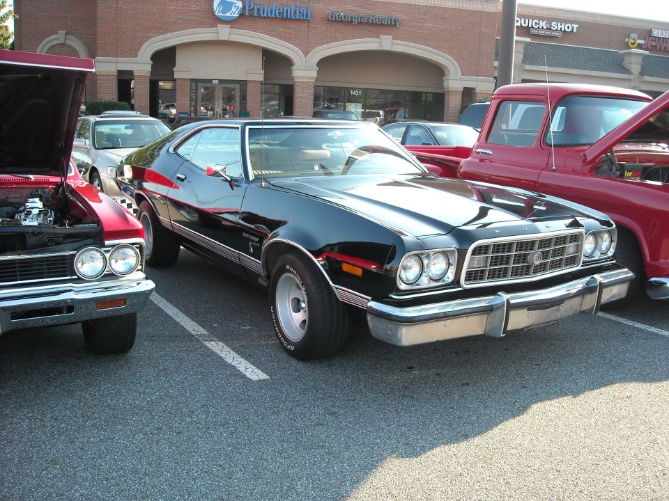 Black 1973 Ford Gran Torino at an outdoor car show