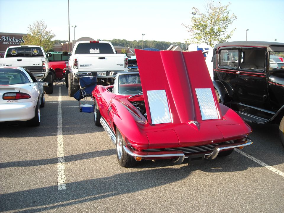 Red Chevrolet Corvette Sting Ray with rear deck open at a car show