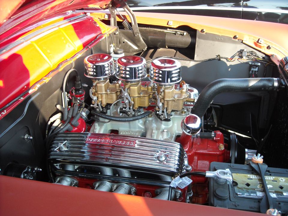 Engine bay with triple-carburetor V8 and chrome air cleaners