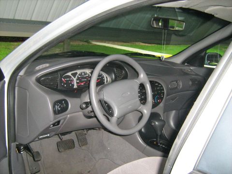 1988 Mercury Grand Marquis - The interior of a car is shown, focusing on the dashboard, steering wheel, and center console. Visible gauges and a gear shifter are presen…
