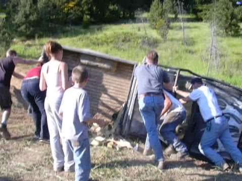 1988 Ford Bronco - A group of people work together to flip a 1988 Ford Bronco back onto its wheels.