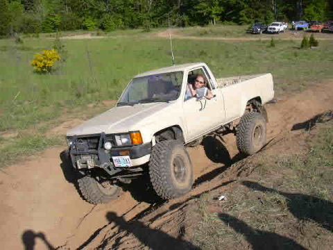 1988 Ford Bronco - This Toyota pickup is navigating a challenging off-road course, demonstrating its capabilities.