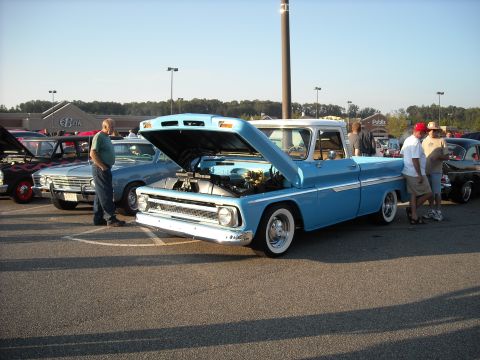 1979 Ford F-150 - A light blue pickup truck with a white roof and chrome accents is displayed with its hood up at a car show.
