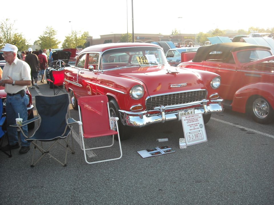 Red 1955 Chevrolet Bel Air with a "FOR SALE" sign in the window