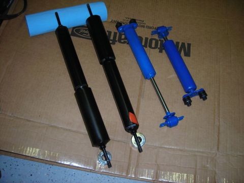 1968 Shelby GT500 - A collection of four shock absorbers, two black and two blue units, are displayed for identification.