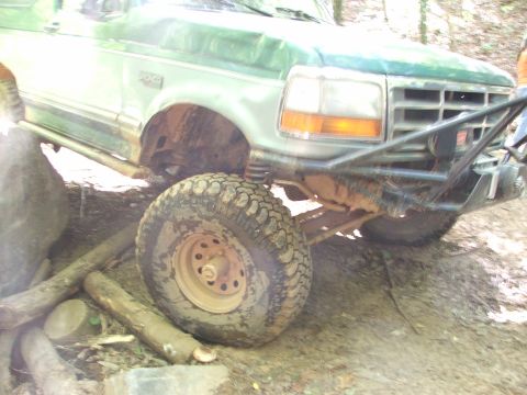 1996 Ford Bronco - Green 1996 Ford Bronco navigates an obstacle course with large tires and a custom bumper.