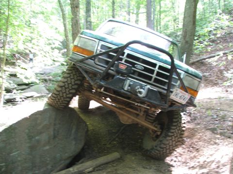 1996 Ford Bronco - Off-road truck with winch navigates a rocky trail, license plate JKL-6741 visible.