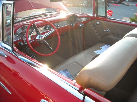 1979 Ford F-150 - The interior of a red 1955 Chevrolet Bel Air convertible shows off its tan leather seats and dashboard.