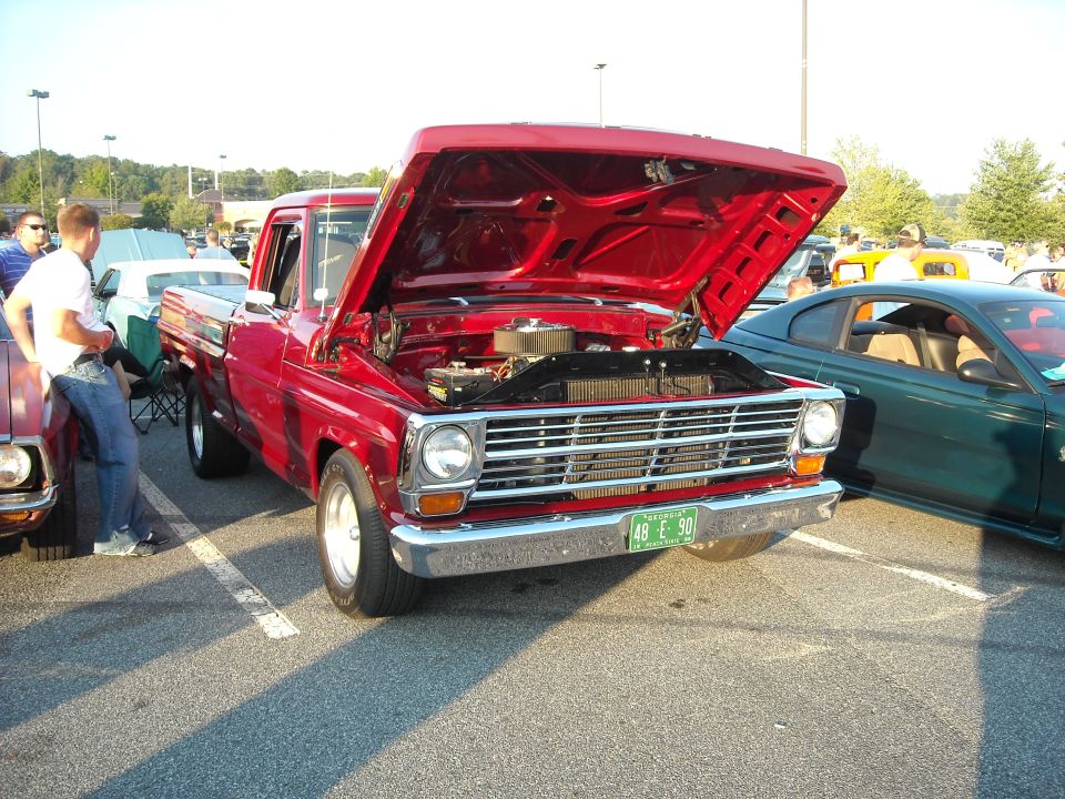 Red pickup truck front view, hood open, showing engine. License plate reads '48 E 90'