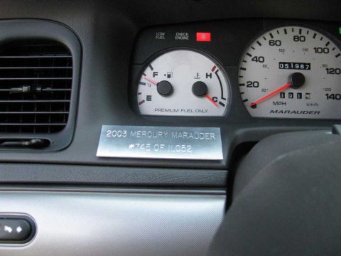 2003 Mercury Marauder - The dashboard of a 2003 Mercury Marauder shows the odometer and fuel gauge, along with a commemorative plaque.