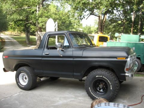 1978 Ford Bronco - This black 1978 Ford Bronco is shown from the side, equipped with off-road tires.
