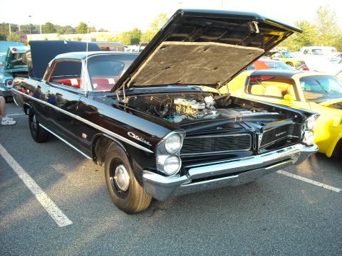 1979 Ford F-150 - 1960 Pontiac Catalina at a car show, hood open to reveal the engine bay.