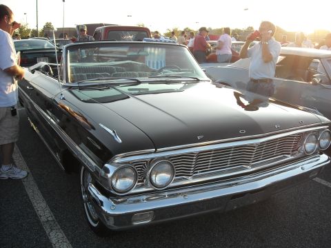 1979 Ford F-150 - Black 1963 Ford Galaxie convertible at a car show with other vehicles present.