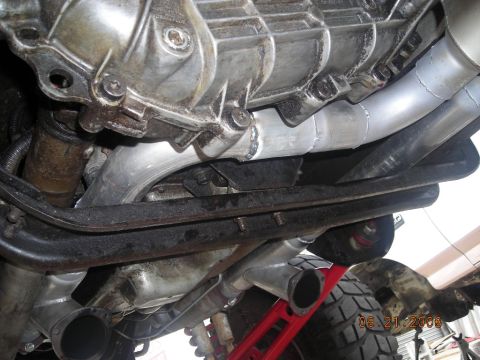 1993 Ford Bronco - Underside view of vehicle exhaust pipes and transmission housing.