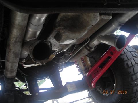 1993 Ford Bronco - Close-up view of the undercarriage, focusing on the exhaust system and suspension components.