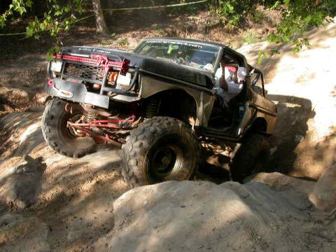 1990 Ford Bronco - This modified 1990 Ford Bronco navigates a challenging off-road course with large tires and a lifted suspension.