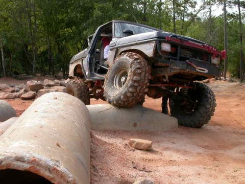 1990 Ford Bronco - This modified 1990 Ford Bronco navigates an off-road obstacle course with large tires and lifted suspension.