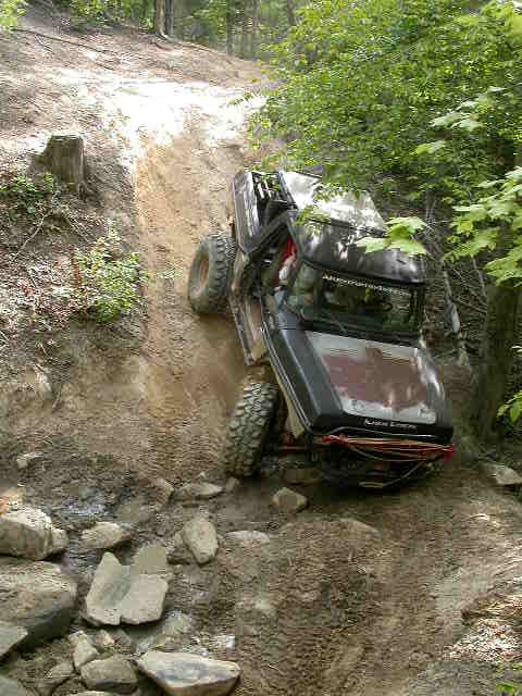 1990 Ford Bronco - This 1990 Ford Bronco is navigating a challenging off-road course on a steep incline.