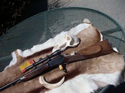 1991 Ford Bronco - Rifle with scope and ammunition displayed on an animal hide with a skull and tusk.