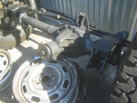1987 Suzuki Samurai - This image shows a vehicle's axle and spare wheels, not a complete 1987 Suzuki Samurai.