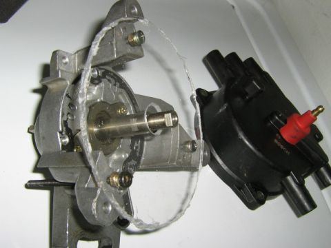 1995 Ford Probe - Close-up of a car's distributor and ignition coil assembly, with the distributor cap removed.