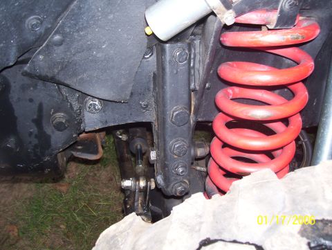 1978 Ford Bronco - Close-up view of a red coil spring suspension system on a vehicle, with visible text overlay indicating "01/17/2006 SUPERMOTORS.NET".