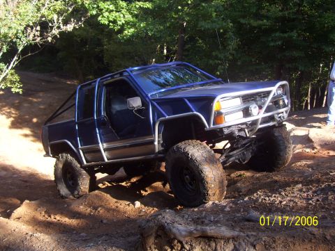 1978 Ford Bronco - This modified SUV navigates a challenging off-road course with its doors removed.