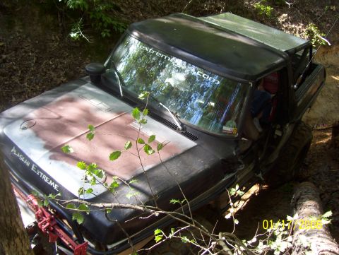 1978 Ford Bronco - This 1978 Ford Bronco is stuck off-road, with 'Alaskan Extreme' visible on the hood.