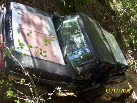 1978 Ford Bronco - This vehicle is tilted on its side in a wooded area, with 'ALASKAN EXTREME' visible on the hood.