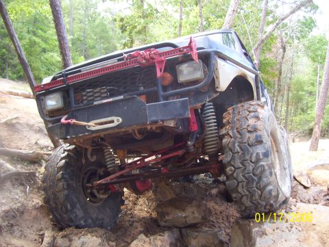 1978 Ford Bronco - This heavily modified off-road vehicle navigates a challenging rocky trail with its front tires high off the ground.