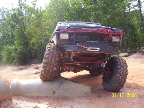 1978 Ford Bronco - This modified 1978 Ford Bronco navigates a challenging off-road course with its front tire elevated on a concrete barrier.