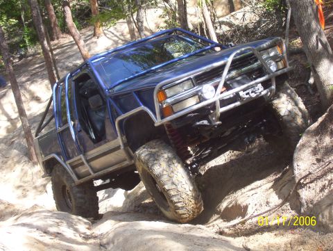 1978 Ford Bronco - This modified off-road vehicle navigates a challenging rocky trail.