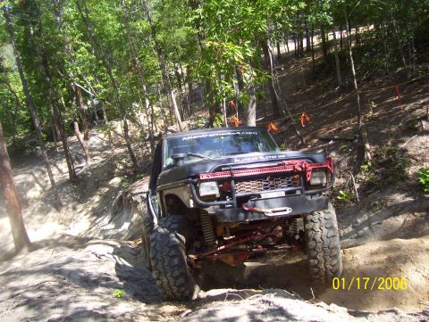 1978 Ford Bronco - This 1978 Ford Bronco navigates a steep, sandy incline surrounded by trees.