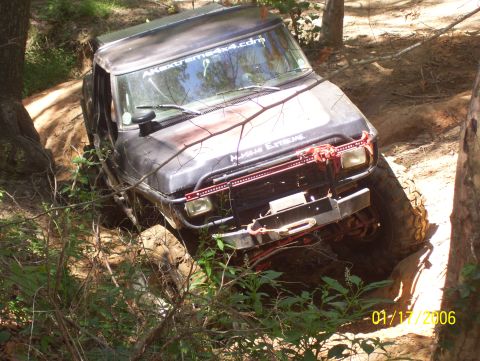 1978 Ford Bronco - This 1978 Ford Bronco is tackling a challenging off-road course in the woods.
