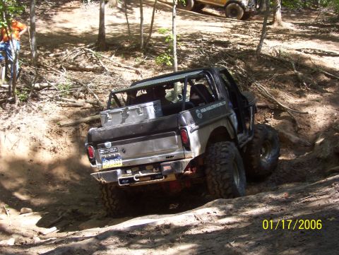 1978 Ford Bronco - A modified 1978 Ford Bronco navigates a challenging dirt trail with another vehicle visible in the background.