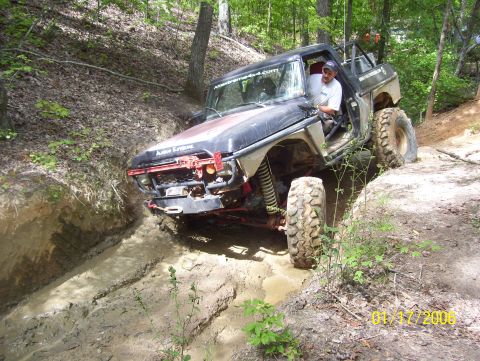 1978 Ford Bronco - This modified 1978 Ford Bronco tackles a challenging off-road course with significant suspension articulation.