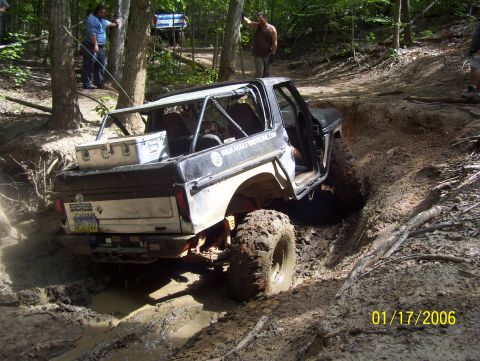 1978 Ford Bronco - This 1978 Ford Bronco navigates a muddy off-road trail with its door open.