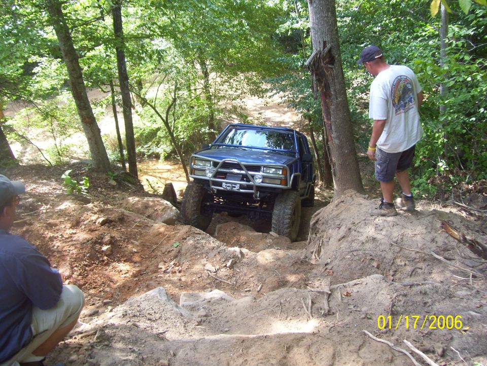 Blue SUV with custom bumper on rocky trail
