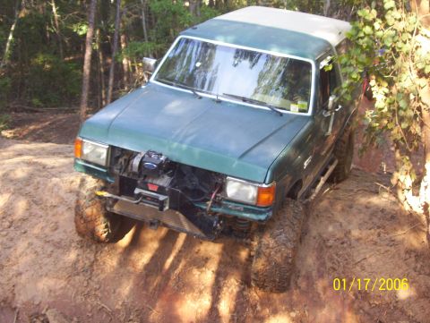 1978 Ford Bronco - Green SUV with winch on front bumper navigates a dirt trail. Date stamp 01/17/2006.