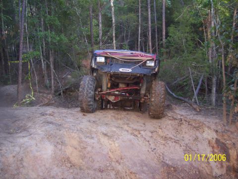 1978 Ford Bronco - This 1978 Ford Bronco is navigating a challenging off-road trail with its lifted suspension and large tires.