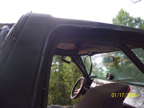 1978 Ford Bronco - Interior view of a modified vehicle, likely a 1978 Ford Bronco, showing a roll cage, steering wheel, and dashboard with gauges. The exterio…