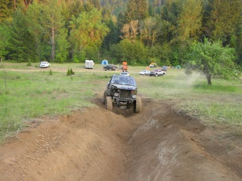 1988 Ford Bronco - 1988 Ford Bronco navigates an off-road obstacle course during an event.